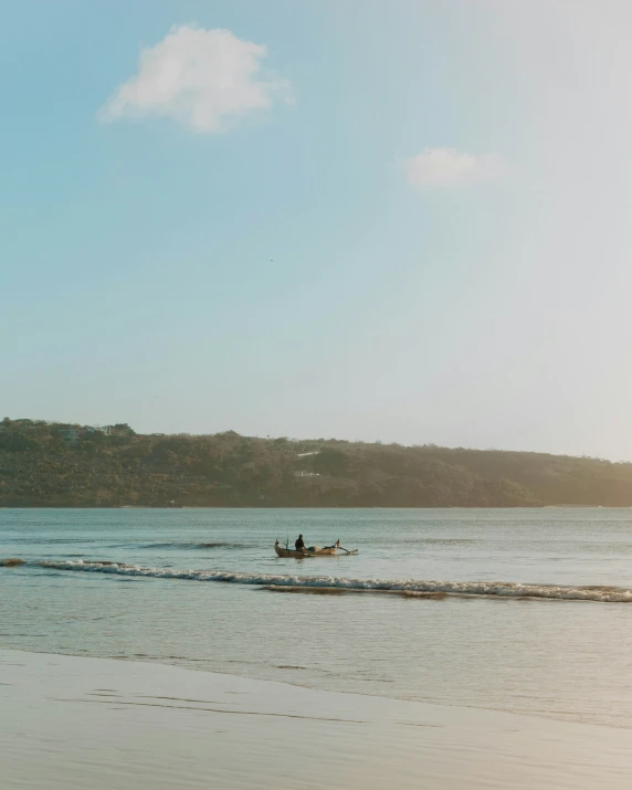 a group of men in a canoe paddling a body of water