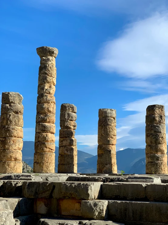 large, old columns stand in front of blue skies