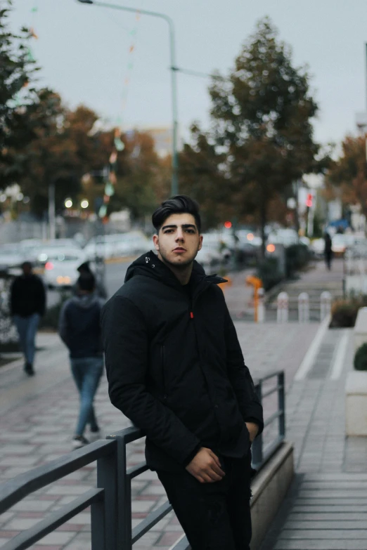 a man standing on a wall next to a fence