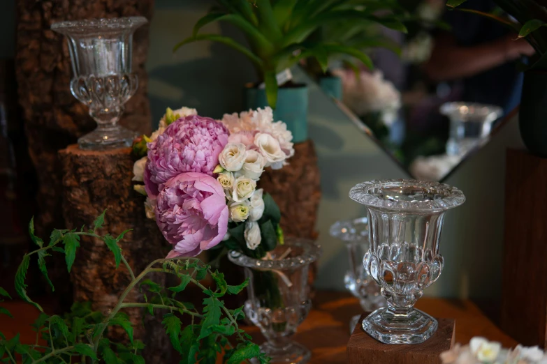 some flowers in vases are sitting on the table