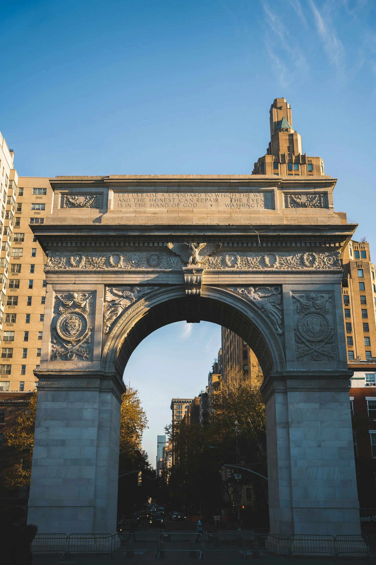 an archway in a city street between two buildings