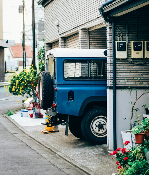 a blue truck parked next to a sidewalk