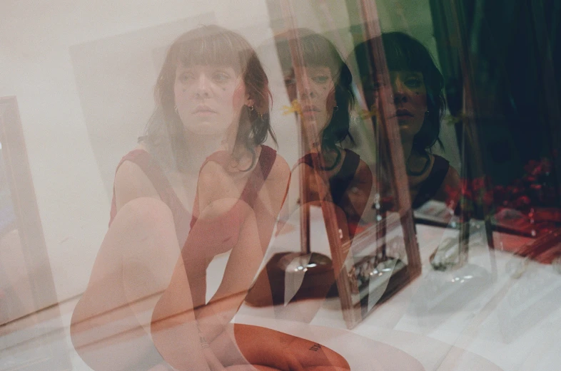 two women with phones in the window of a store