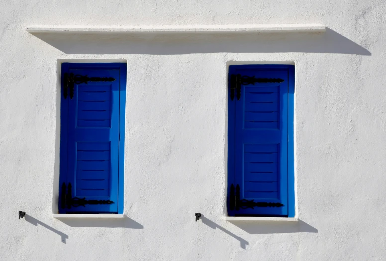 two blue window seats facing each other outside