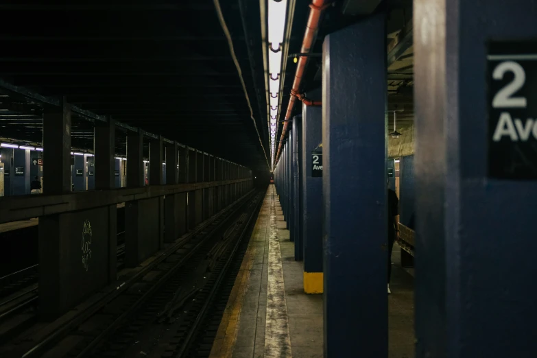 a long train pulling into a station next to two doors