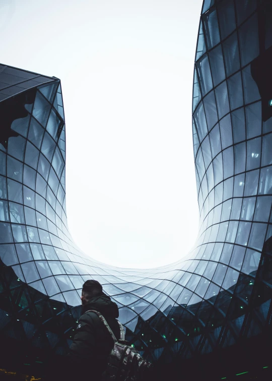 a person standing in front of a futuristic building