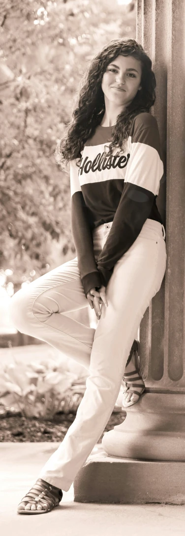 a young woman leaning on the pillars of a building