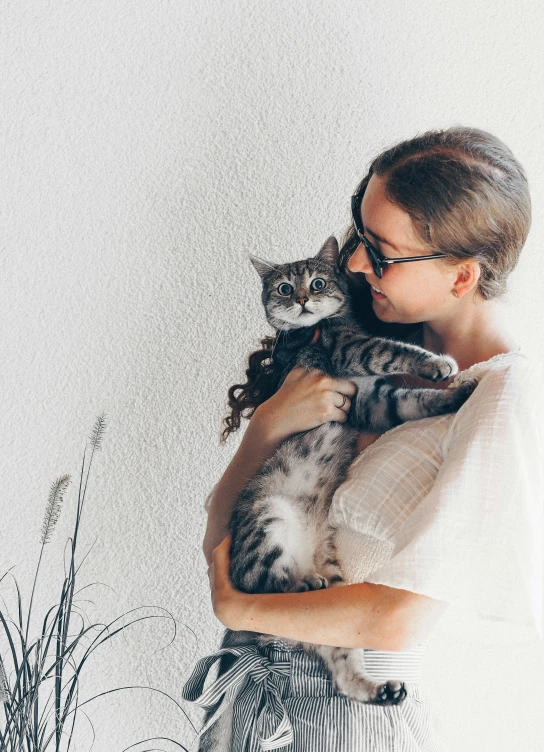 a person holding a cat in their arms