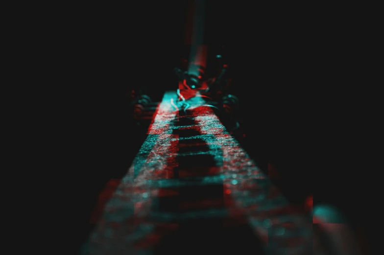 a blurry picture of a long brick road with a red and blue line down the middle