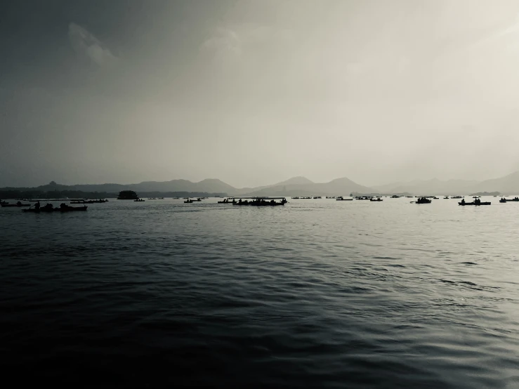 several boats float in the distance on the ocean