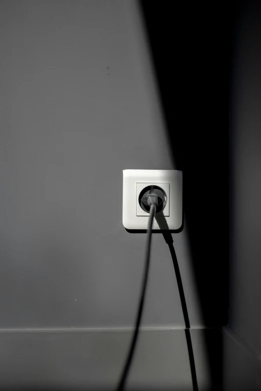 a black and white po of a light switch on a wall