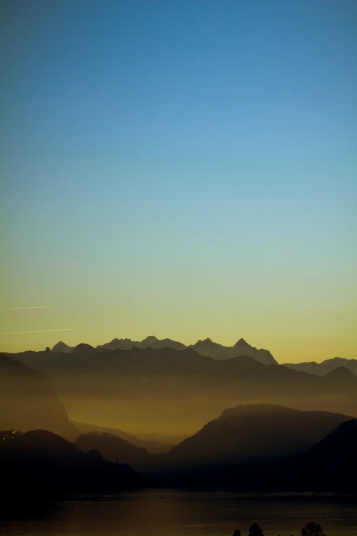 an airplane is flying over the mountains above