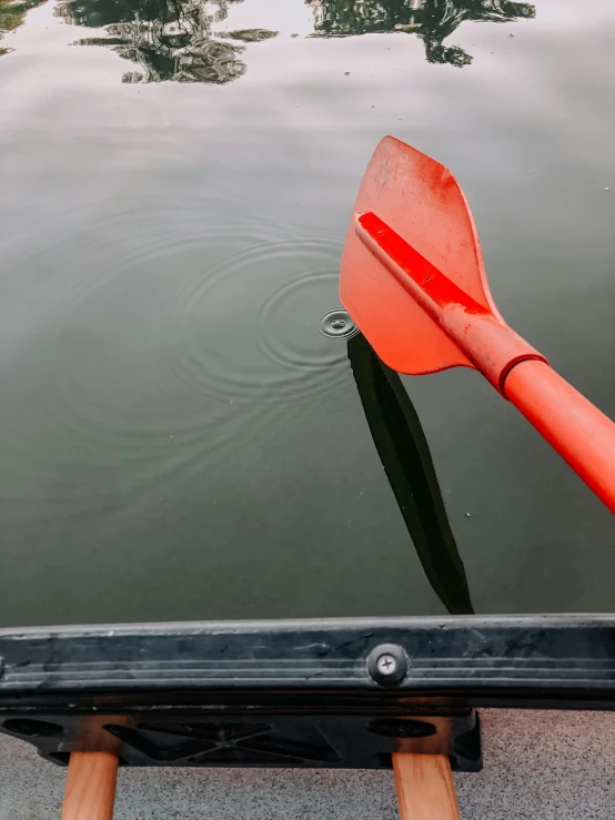 an orange kayak is floating in the water