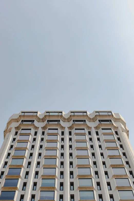 a large building with lots of windows against a blue sky