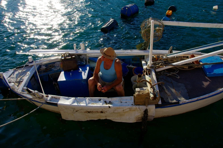 the woman sits in the front of the boat