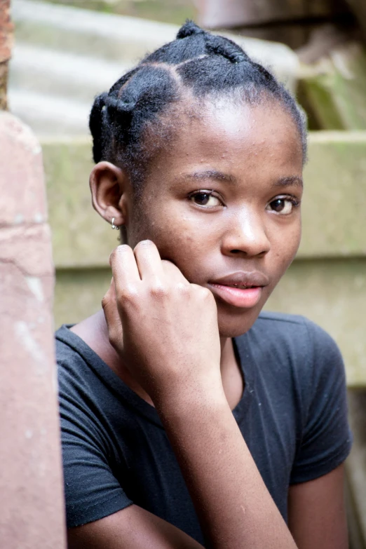 young woman wearing a black t - shirt looking forward