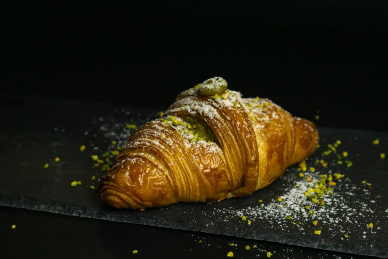 a pastry on a  board covered in powdered sugar