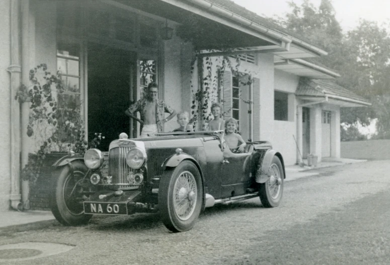 an old car sits outside of a building