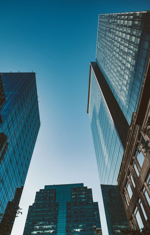 two tall building near one another with a sky background