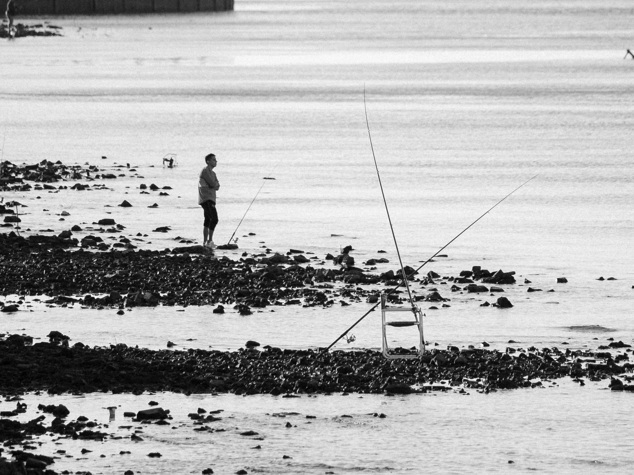 a couple of men fishing in a body of water