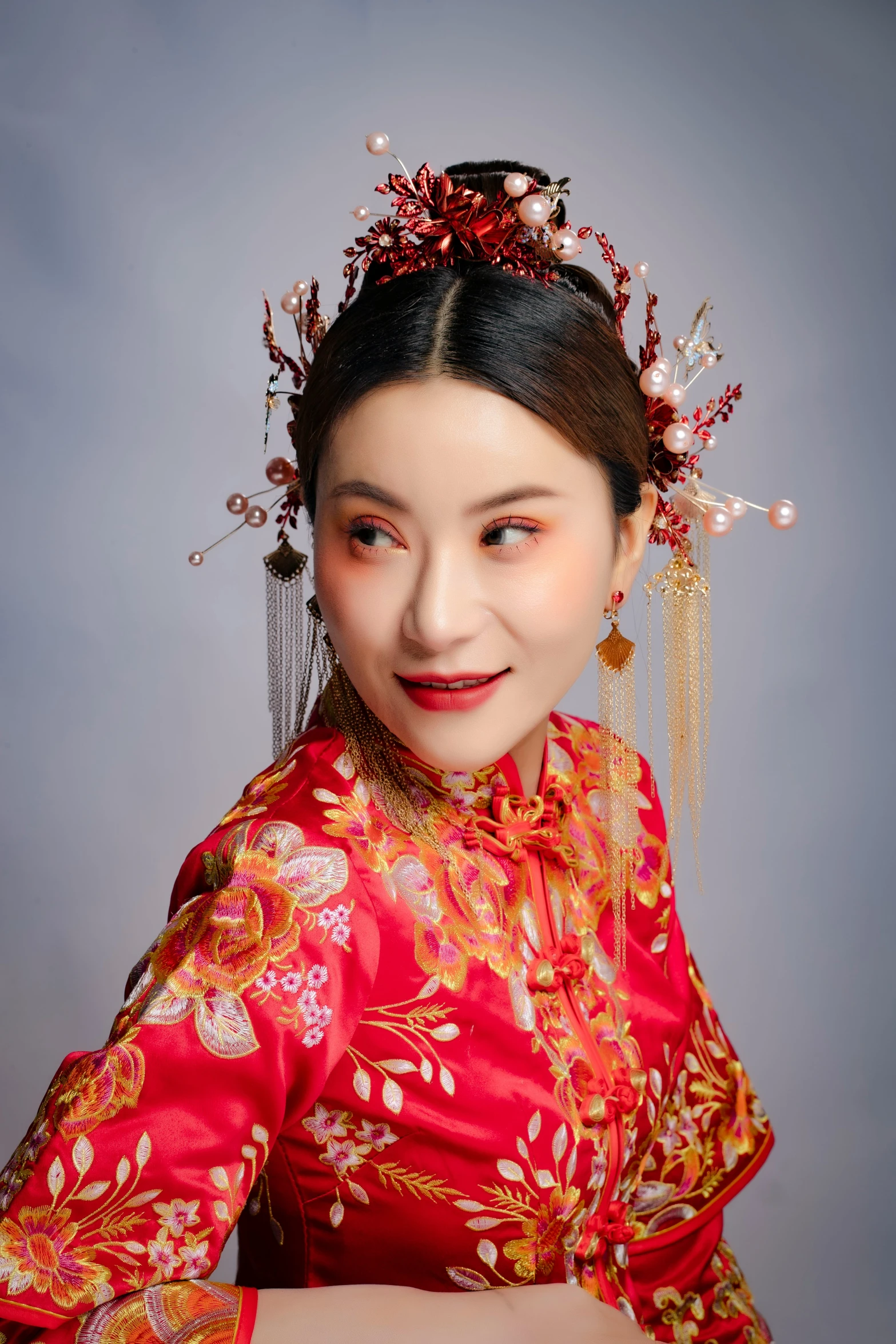 a close up of a woman with a necklace and red dress