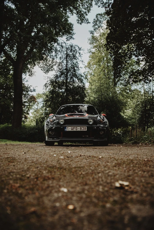 a black car is parked in the forest