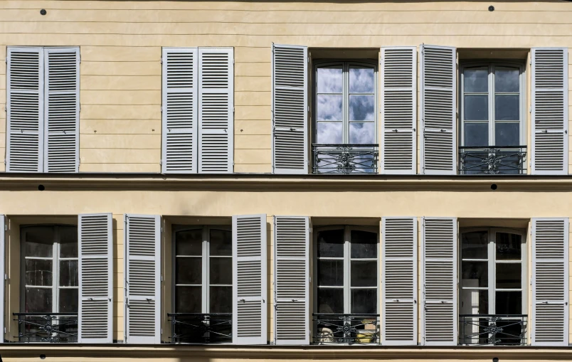 the facade of a two story building with large windows