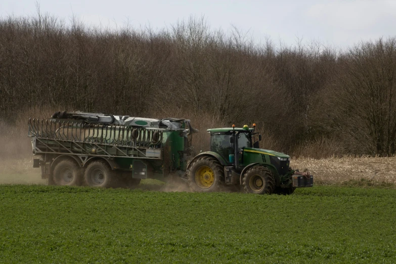 two large tractors pulling over an open field