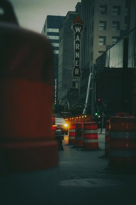 an intersection with lots of traffic and lights and construction signs