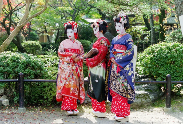 two women dressed up in geisha and traditional japanese dress