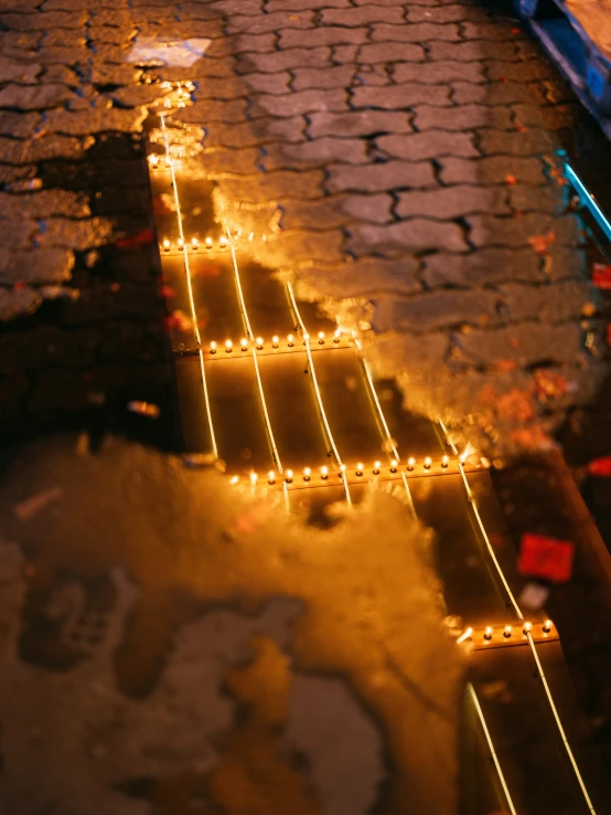 lighted sidewalk steps are decorated with small lights