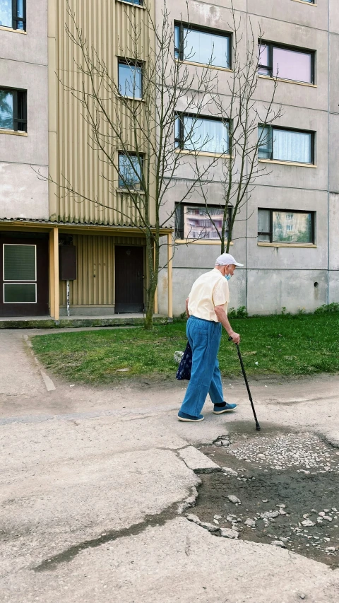 a man walking with a stick on a street