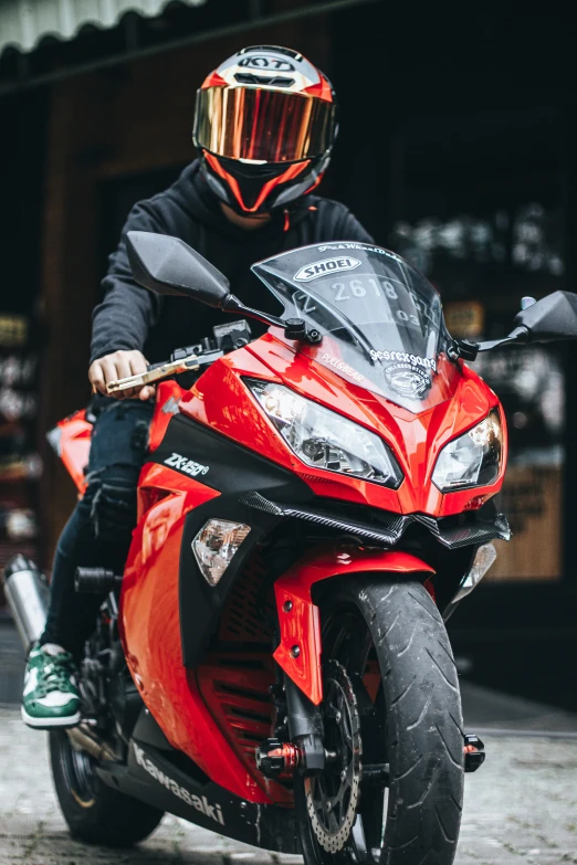 a motorcycle rider wearing a helmet and black jacket