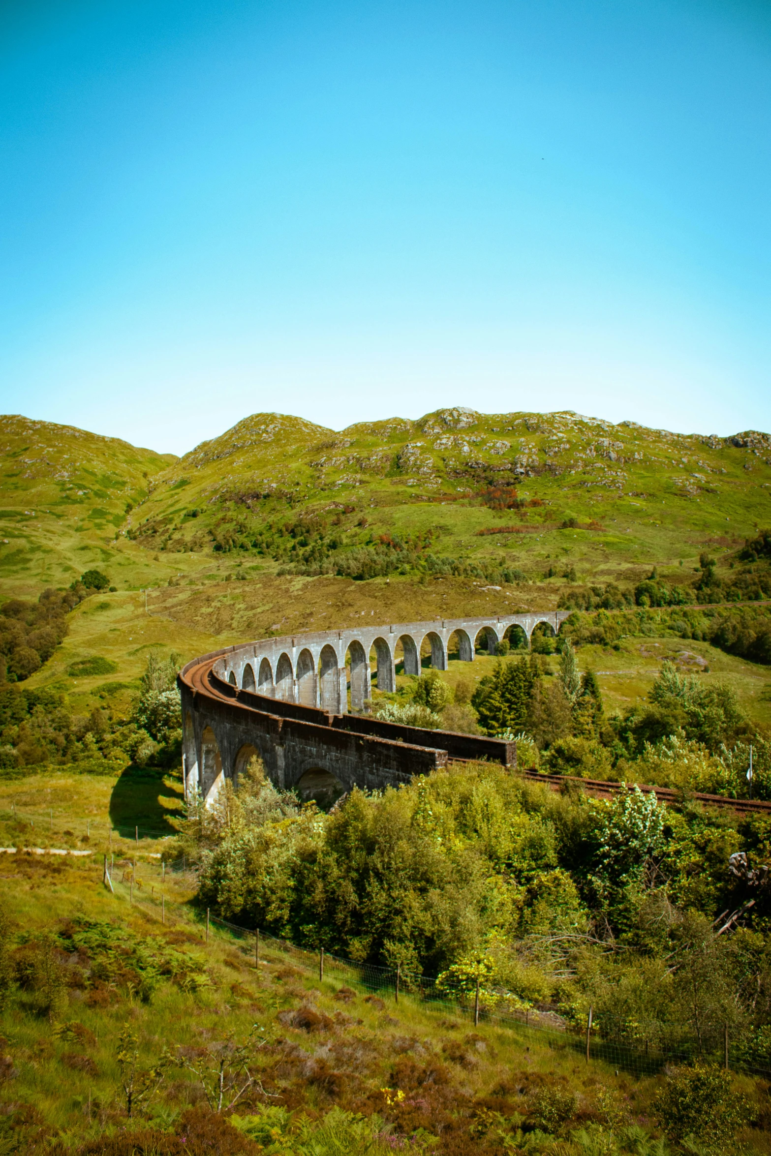 a train traveling down the tracks on a bridge