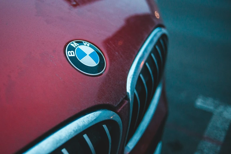 a bmw badge is shown on a red car