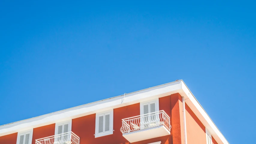 an apartment building with balconies on top of it