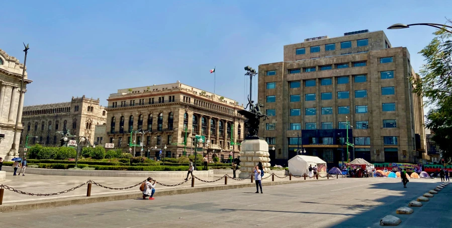 people standing in front of some old buildings