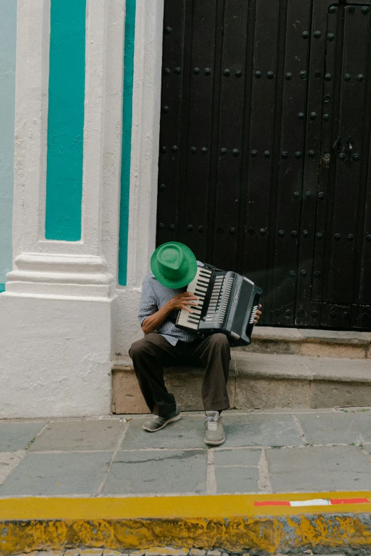 a man sitting in front of an accordion playing the music