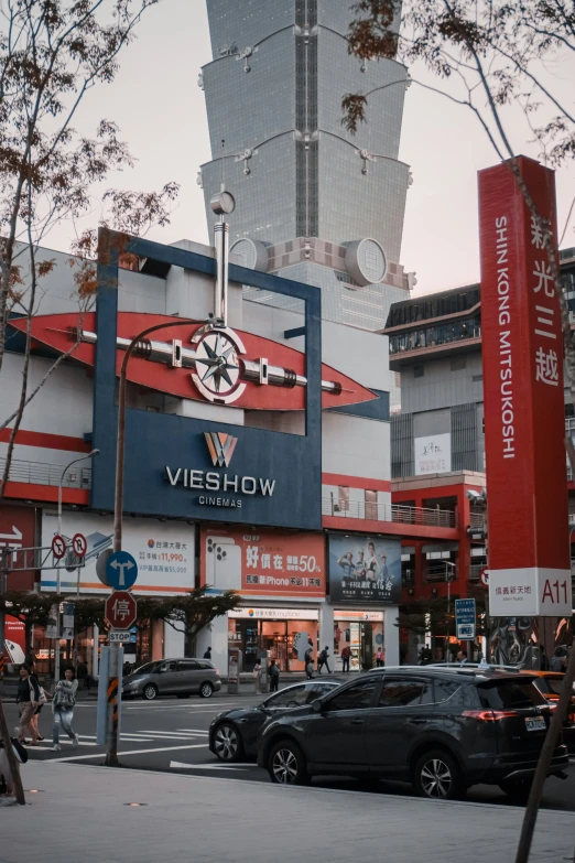 a building in an asian city with tall clocks on the top