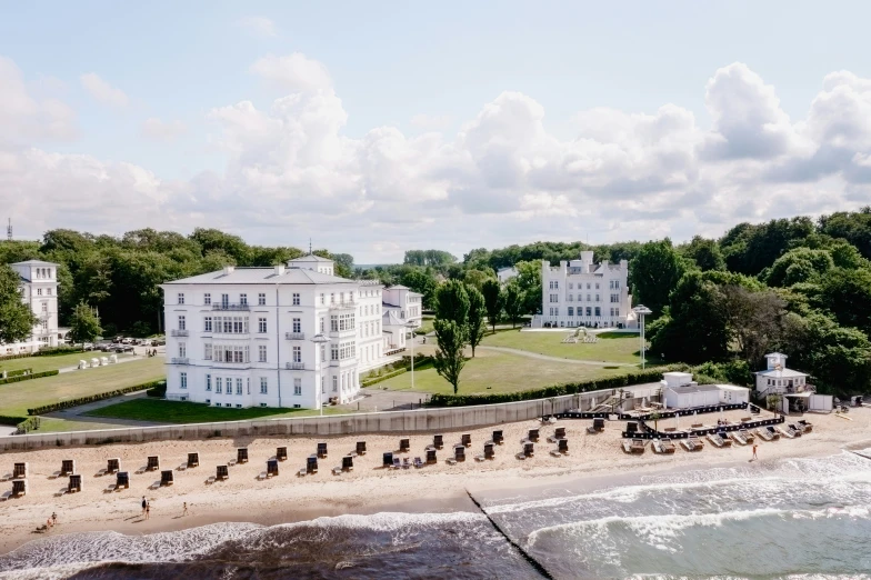 a large white mansion next to the ocean