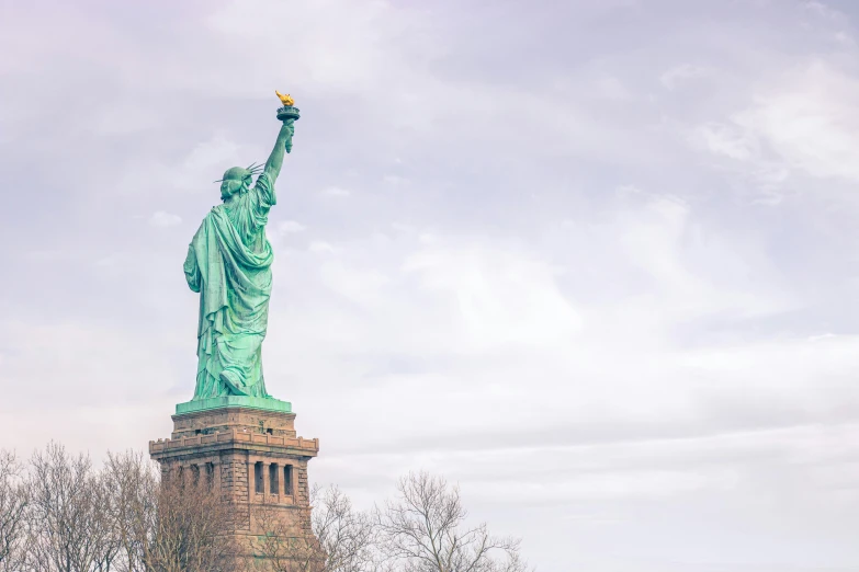 the statue of liberty stands tall in the middle of the street