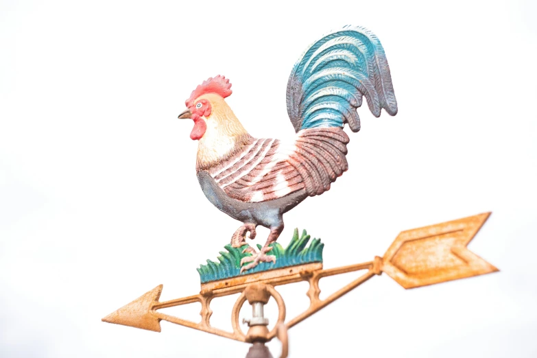 a rooster weather vane on a weather beaten day