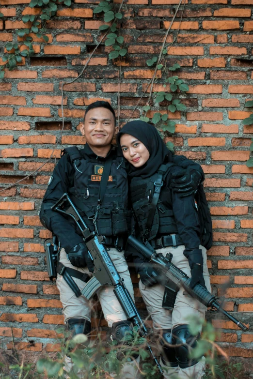 a man and woman posing for the camera with guns