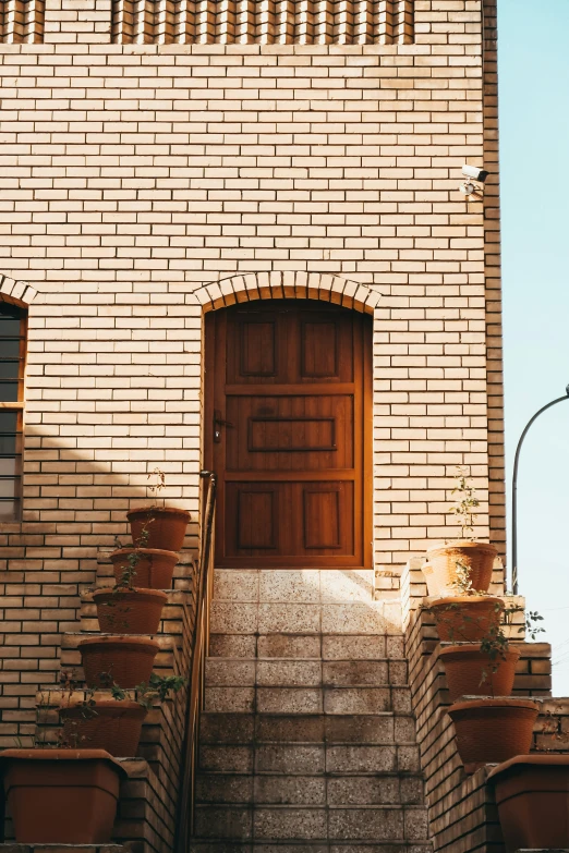 a brick building with two large doors and two stairs