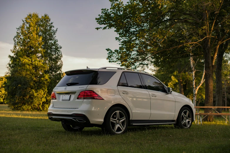 a white vehicle parked on a grass covered field