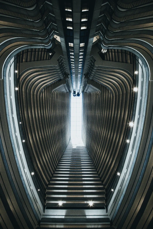 a spiral staircase with lights in a very big building