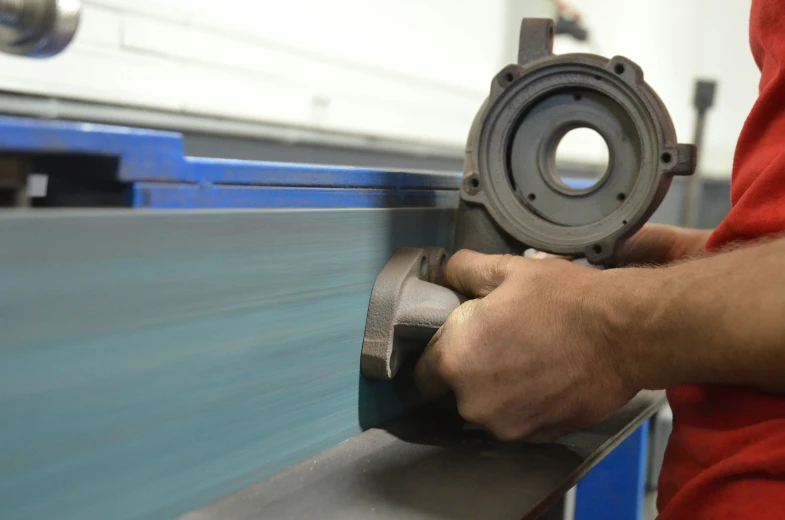 a worker using an industrial tool to grind metal