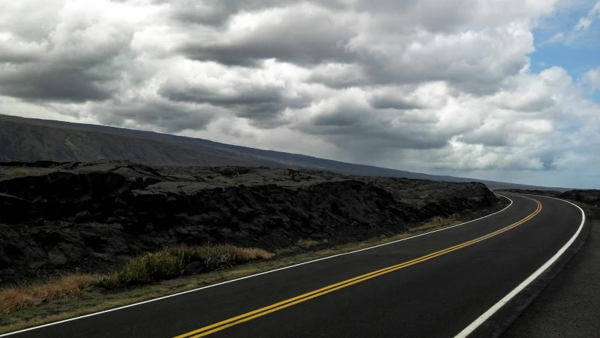 a car on the side of a road that is winding