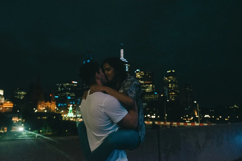 a man and woman hugging in the dark