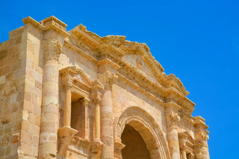 an ancient looking building against a blue sky